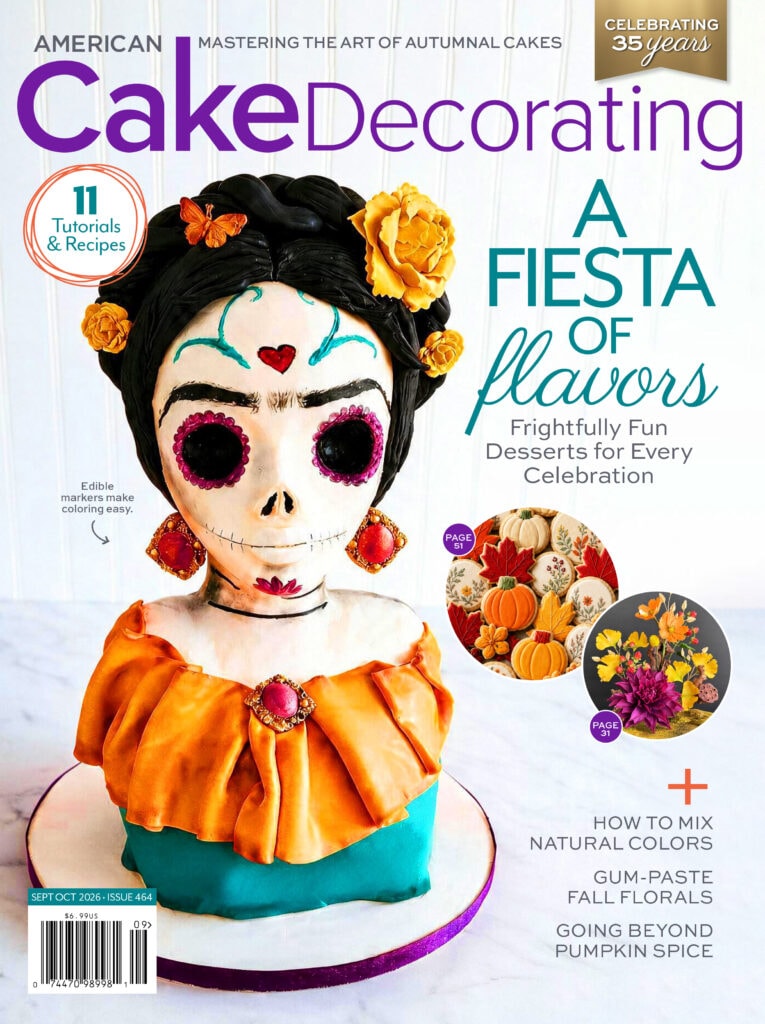 American Cake Decorating September/October 2026 magazine cover featuring a Día de los Muertos-inspired sculpted cake with colorful autumn details.