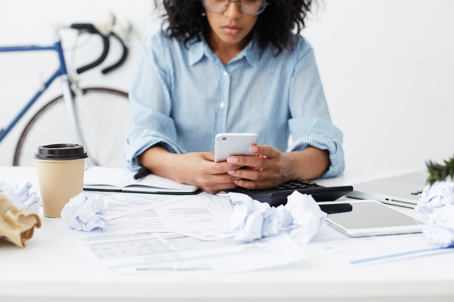 Small business owner managing paperwork and administrative tasks at her desk